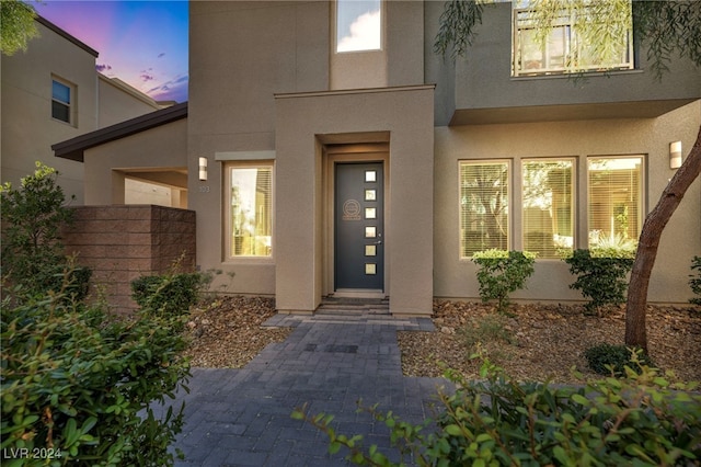 view of exterior entry at dusk