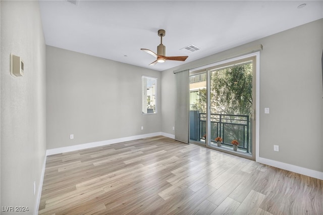 empty room with ceiling fan and light wood-type flooring