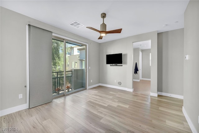 empty room with light wood-type flooring and ceiling fan