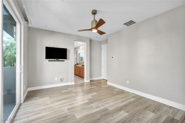 empty room featuring ceiling fan and light wood-type flooring