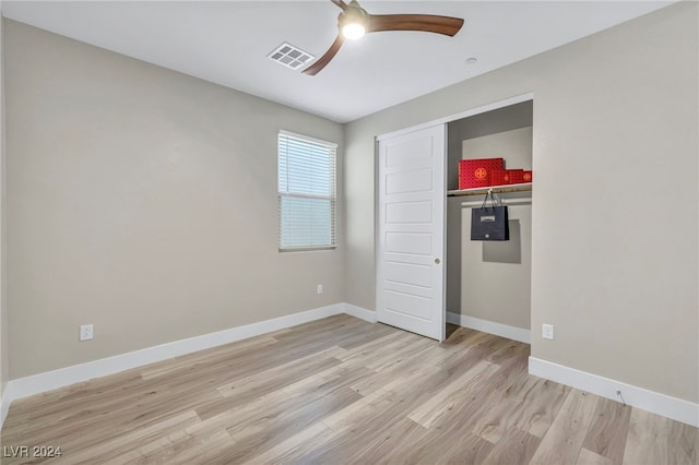 unfurnished bedroom featuring a closet, light wood-type flooring, and ceiling fan