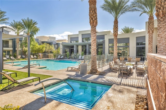 view of swimming pool with a hot tub and a patio