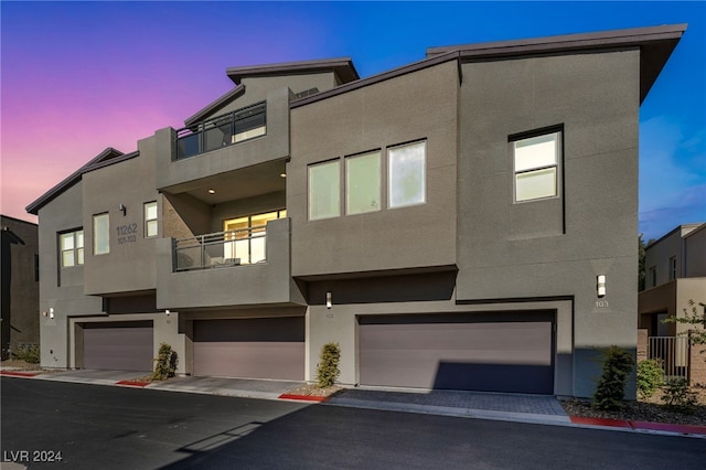 contemporary home featuring a balcony and a garage