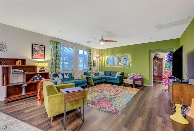 living room with ceiling fan and dark wood-type flooring