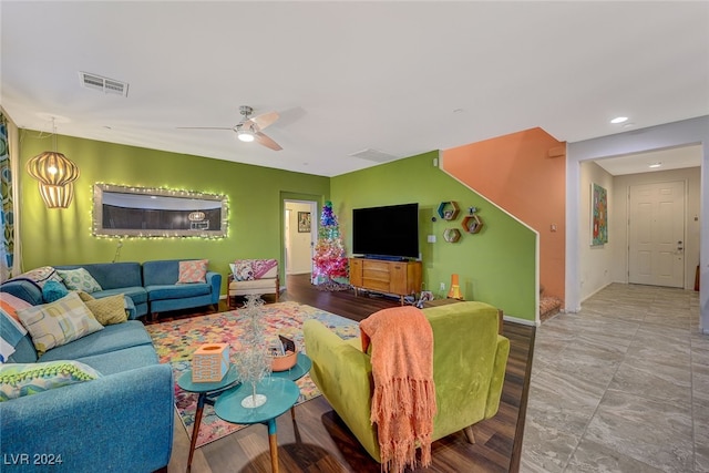 living room featuring ceiling fan and light hardwood / wood-style flooring