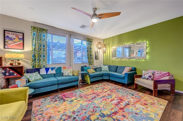 living room featuring ceiling fan and dark wood-type flooring