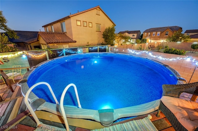 view of pool at dusk