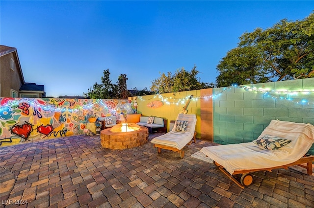 patio terrace at dusk featuring an outdoor fire pit