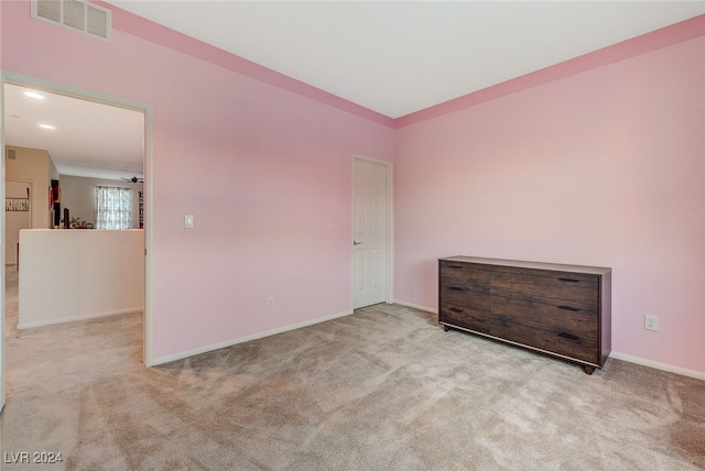 empty room with light colored carpet and ceiling fan