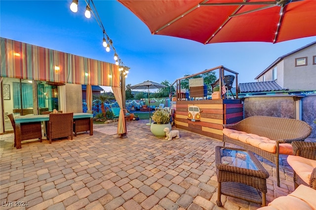 patio terrace at dusk featuring an outdoor hangout area