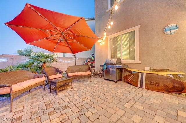 patio terrace at dusk featuring an outdoor living space and a grill