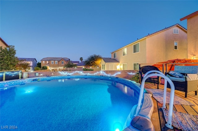 view of pool at dusk