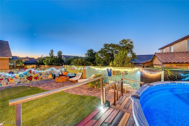 view of pool at dusk