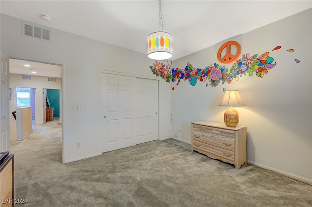 bedroom with light carpet and a closet