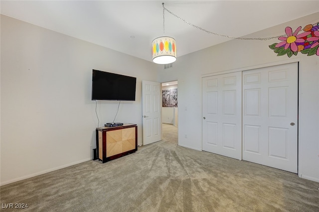 unfurnished bedroom featuring carpet and a closet