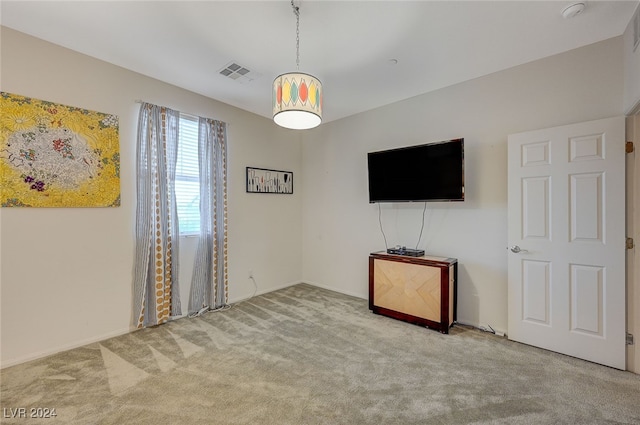 unfurnished living room featuring light colored carpet