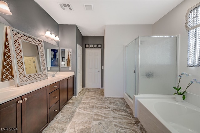 bathroom with vanity and shower with separate bathtub