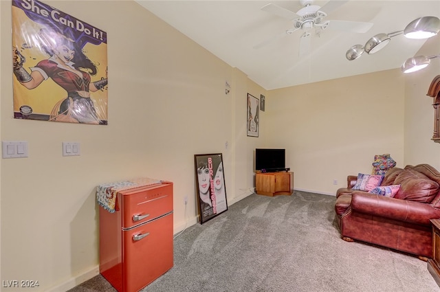 living area featuring carpet and ceiling fan