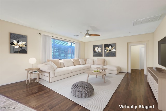 living room with ceiling fan and dark wood-type flooring