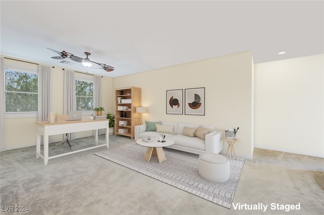 carpeted living room with ceiling fan