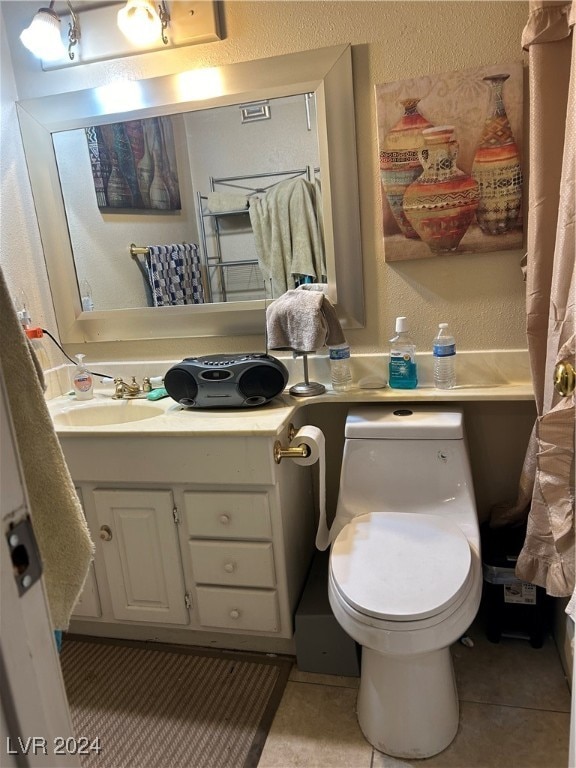 bathroom with tile patterned floors, vanity, and toilet