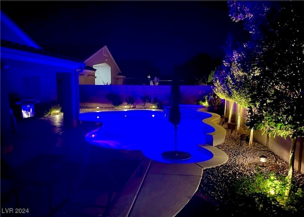 view of pool at night