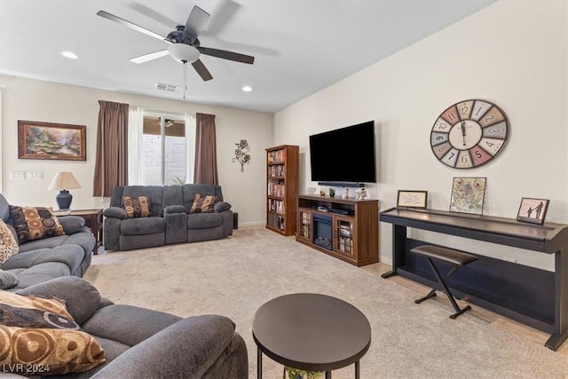 living room featuring light colored carpet and ceiling fan