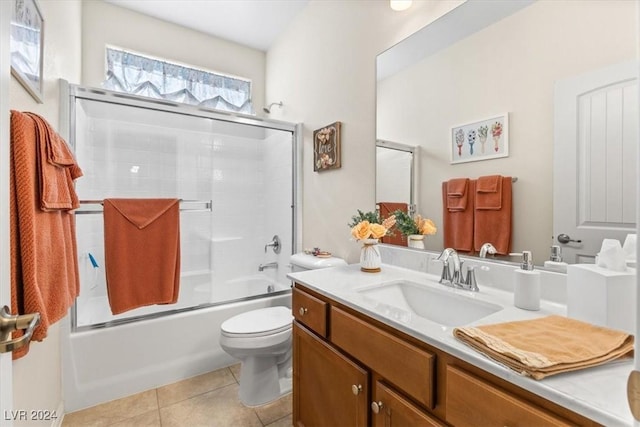 full bathroom with vanity, tile patterned floors, shower / bath combination with glass door, and toilet