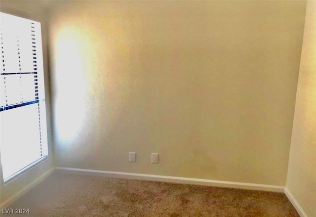 unfurnished room featuring carpet flooring