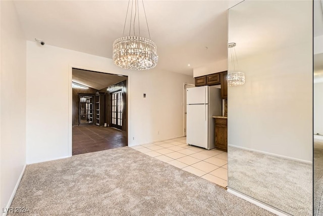 408 Rossmoyne Ave, North Las Vegas, NV 89030 - unfurnished dining area with a chandelier, light tile patterned flooring, light colored carpet, and baseboards