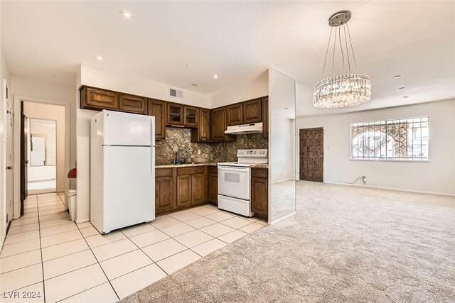 408 Rossmoyne Ave, North Las Vegas, NV 89030 - kitchen featuring white appliances, a sink, under cabinet range hood, tasteful backsplash, and a chandelier