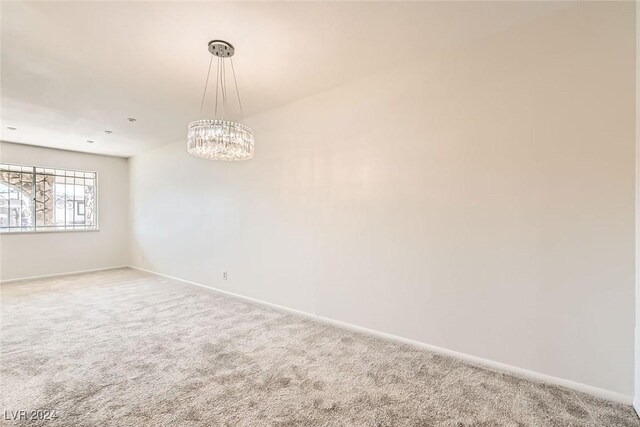 408 Rossmoyne Ave, North Las Vegas, NV 89030 - carpeted spare room with baseboards and a chandelier