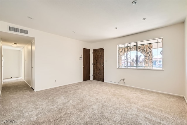 unfurnished room with light carpet