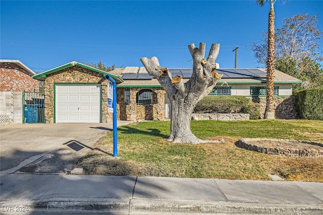 view of front of home featuring solar panels, a garage, and a front lawn