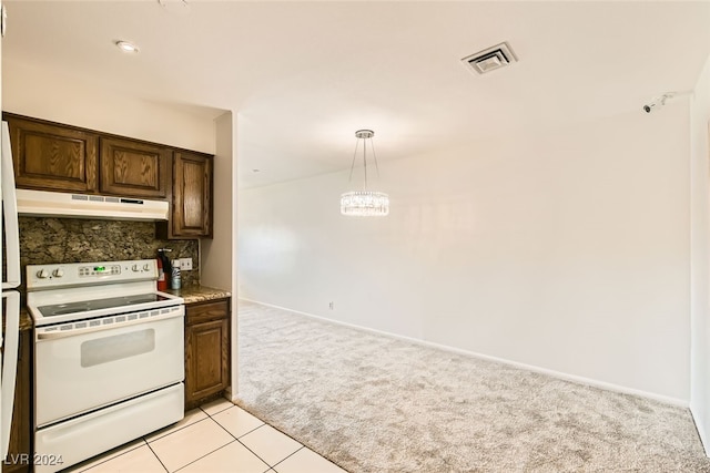 kitchen featuring backsplash, light colored carpet, pendant lighting, electric range, and a notable chandelier