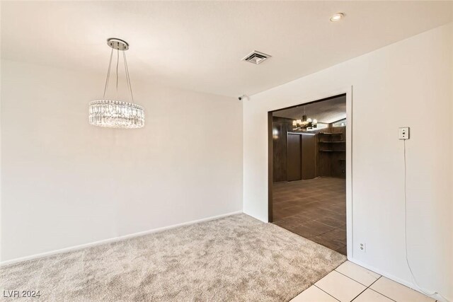 408 Rossmoyne Ave, North Las Vegas, NV 89030 - carpeted spare room featuring a chandelier, tile patterned flooring, and baseboards