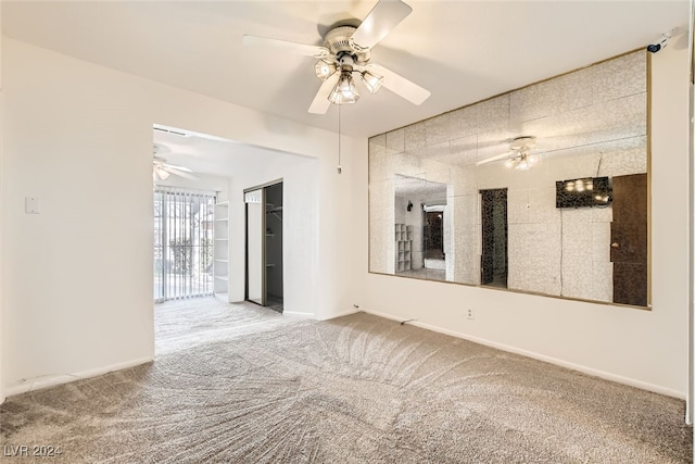 spare room with carpet flooring and ceiling fan