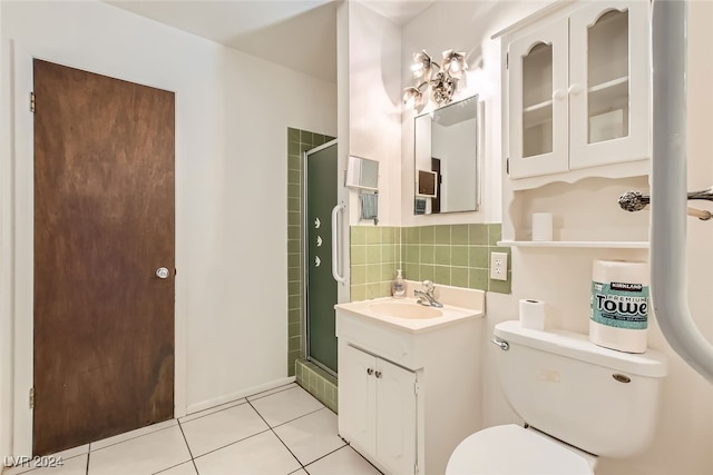 bathroom with vanity, tile patterned floors, decorative backsplash, toilet, and a shower with shower door