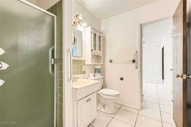 bathroom featuring tile patterned floors, toilet, decorative backsplash, vanity, and a shower with shower door