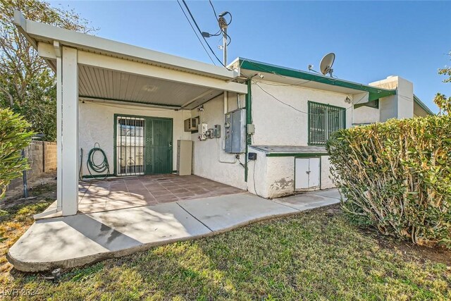 408 Rossmoyne Ave, North Las Vegas, NV 89030 - back of house featuring a patio, stucco siding, and fence