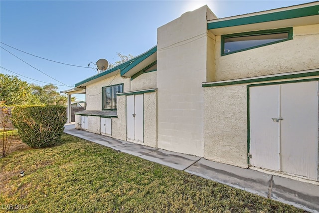 view of side of home with a lawn