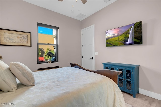 bedroom with ceiling fan and light hardwood / wood-style flooring