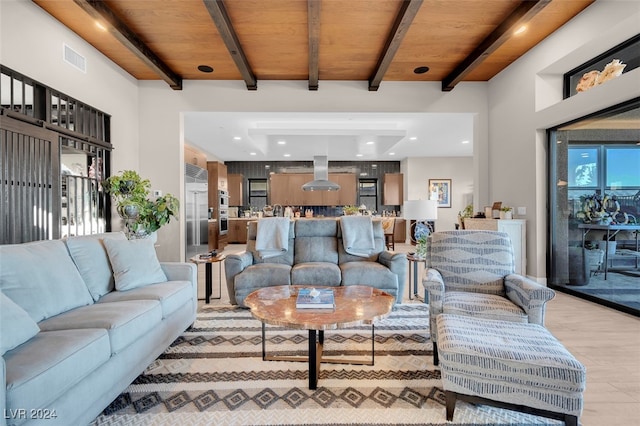 living room with light hardwood / wood-style floors, beamed ceiling, and wooden ceiling