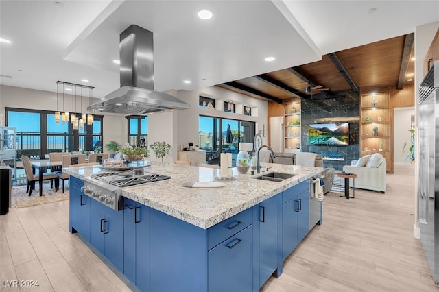 kitchen with an island with sink, light hardwood / wood-style flooring, stainless steel appliances, wooden ceiling, and sink