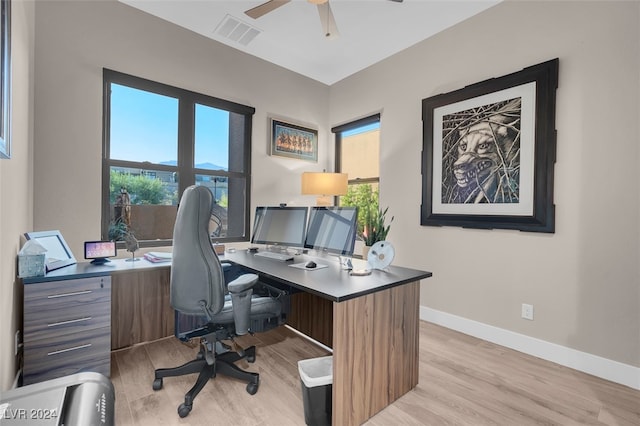 office with light hardwood / wood-style floors and ceiling fan