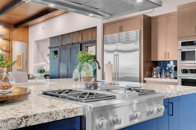 kitchen featuring ventilation hood, beam ceiling, stainless steel appliances, and light stone countertops