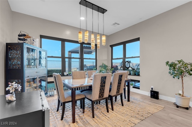 dining room with plenty of natural light, a chandelier, and light wood-type flooring