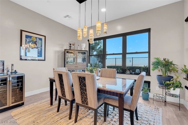 dining area featuring light hardwood / wood-style flooring and beverage cooler