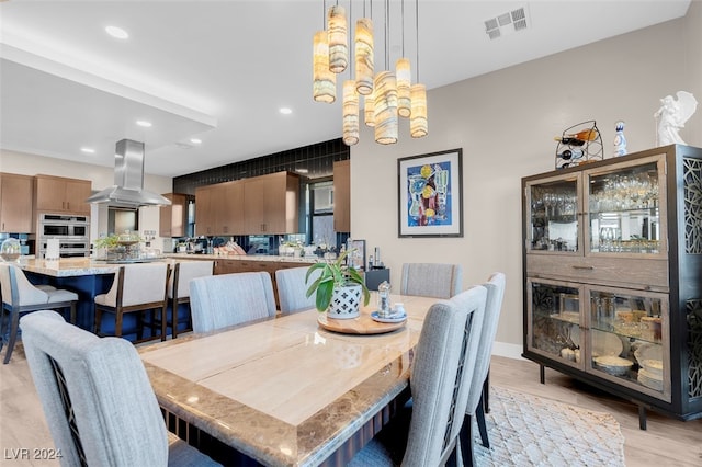 dining room featuring an inviting chandelier and light wood-type flooring