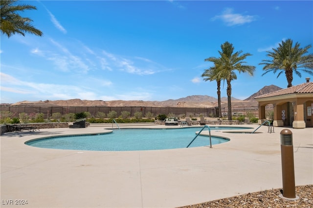 view of pool with a mountain view and a patio area